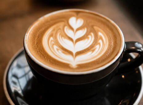 Latte art coffee cup at Rise & Grind Paphos