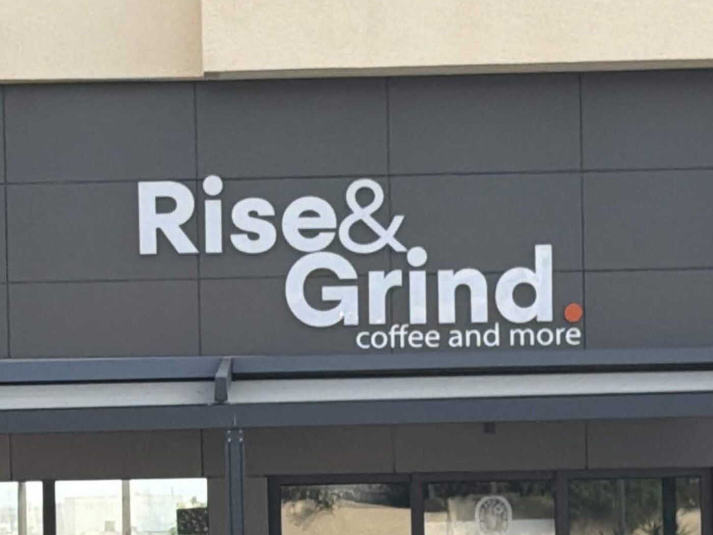 Rise & Grind — Coffee and More illuminated facade sign